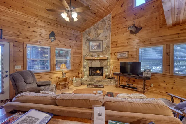 a living room with furniture a fireplace and a wall painting