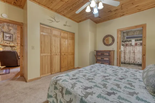 a bedroom with a large bed and a chandelier