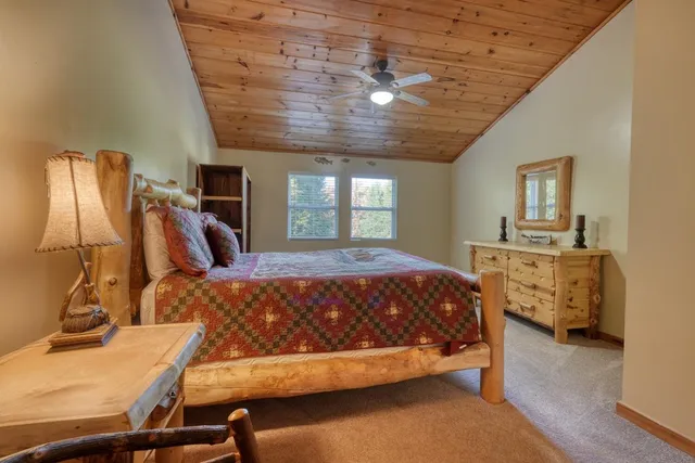 a spacious bedroom with a bed and a dresser