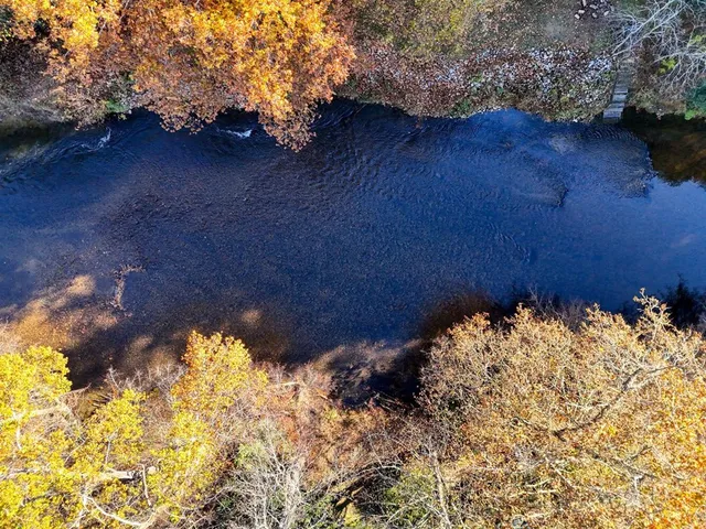 a view of water with a yard