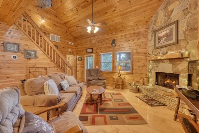 a living room with furniture a fireplace and a flat screen tv