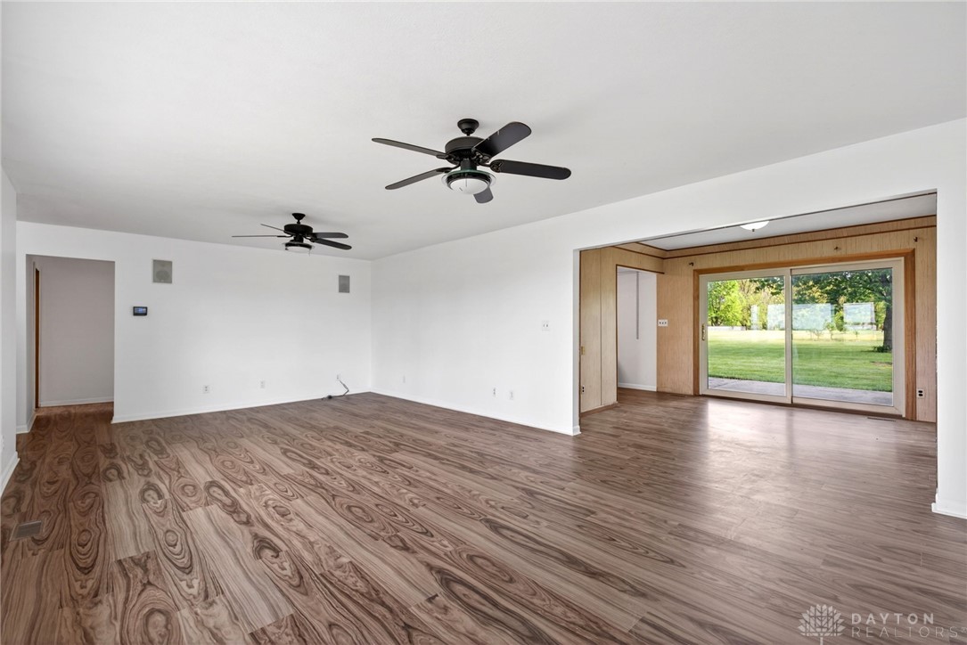 1005 Free Road New Carlisle, OH 45344 - Photo 9 of 43 This expansive living area features durable flooring and convenient sliding glass doors leading to the outdoors.