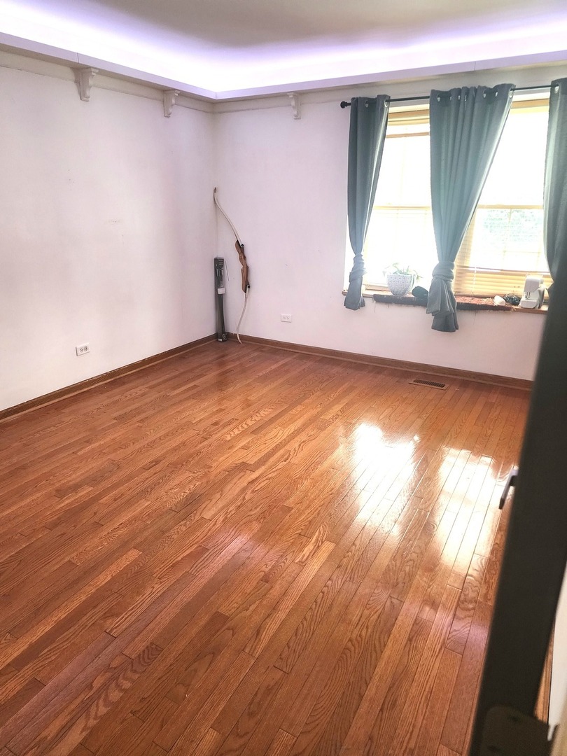 448 Bridle Trail, Unit 448 Wheeling, IL 60090 - Photo 11 of 14 an empty room with wooden floor and windows