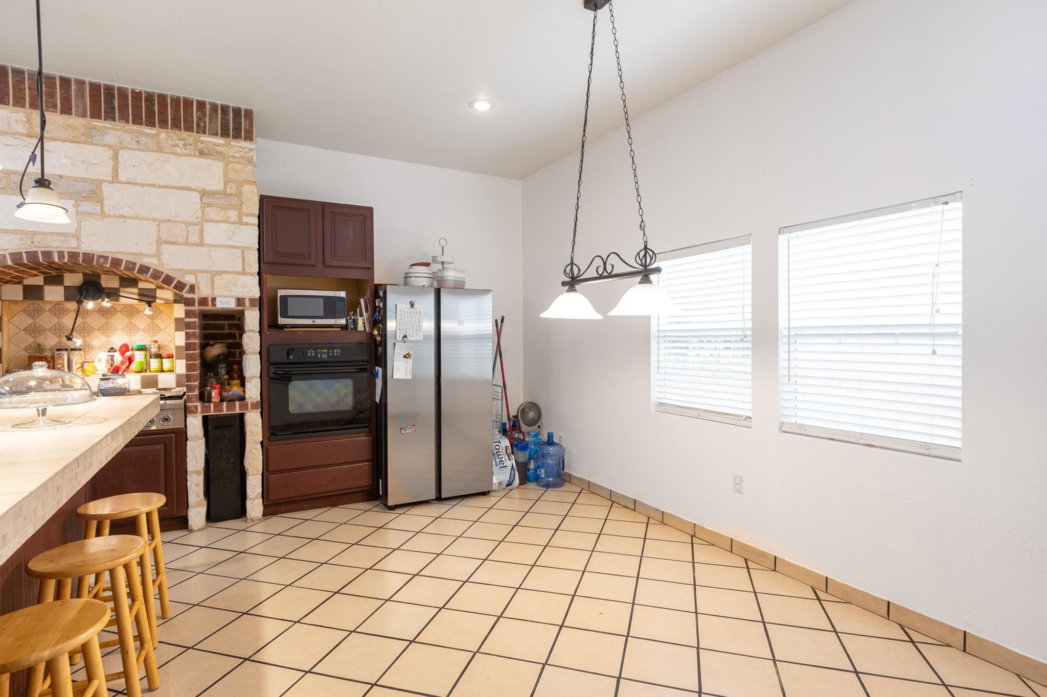 176 Old Lexington Road, Unit C Elgin, TX 78621 - Photo 12 of 31 a kitchen with stainless steel appliances kitchen island granite countertop a refrigerator and a stove top oven