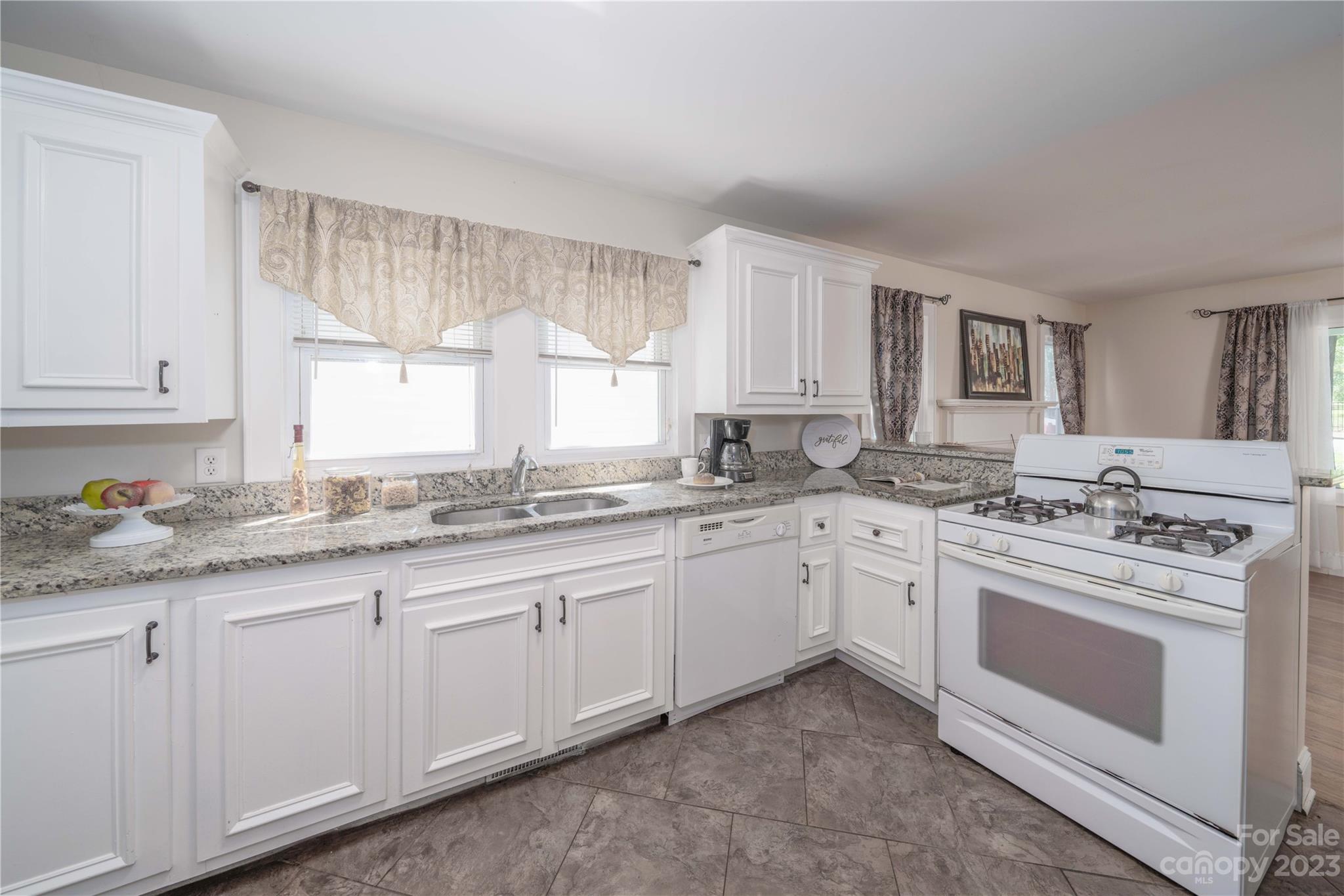 507 Cook Street Kannapolis, NC 28083 - Photo 20 of 38 a kitchen with granite countertop white cabinets and white stainless steel appliances