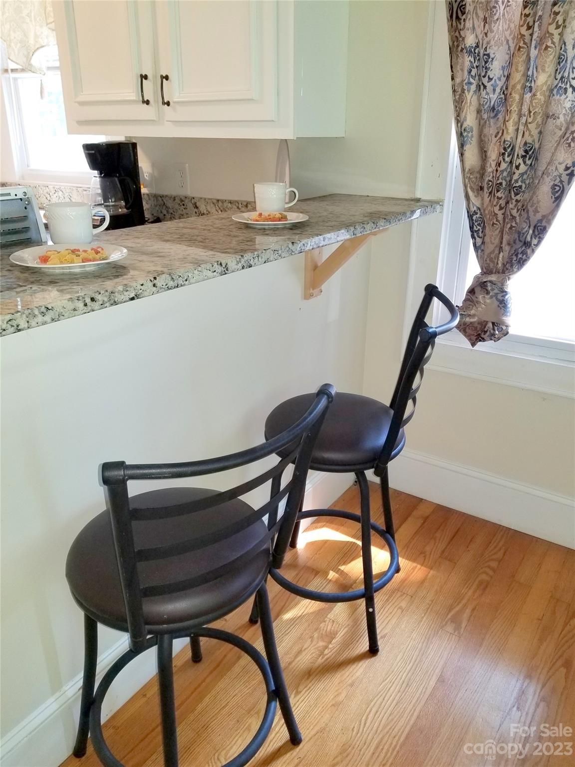 507 Cook Street Kannapolis, NC 28083 - Photo 23 of 38 a view of dining room and kitchen with furniture and wooden floor
