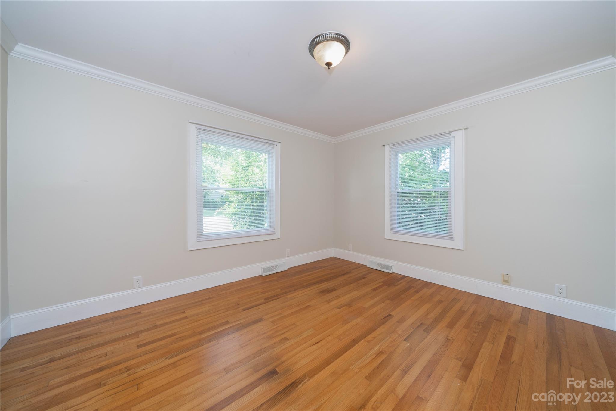 507 Cook Street Kannapolis, NC 28083 - Photo 27 of 38 an empty room with wooden floor and windows