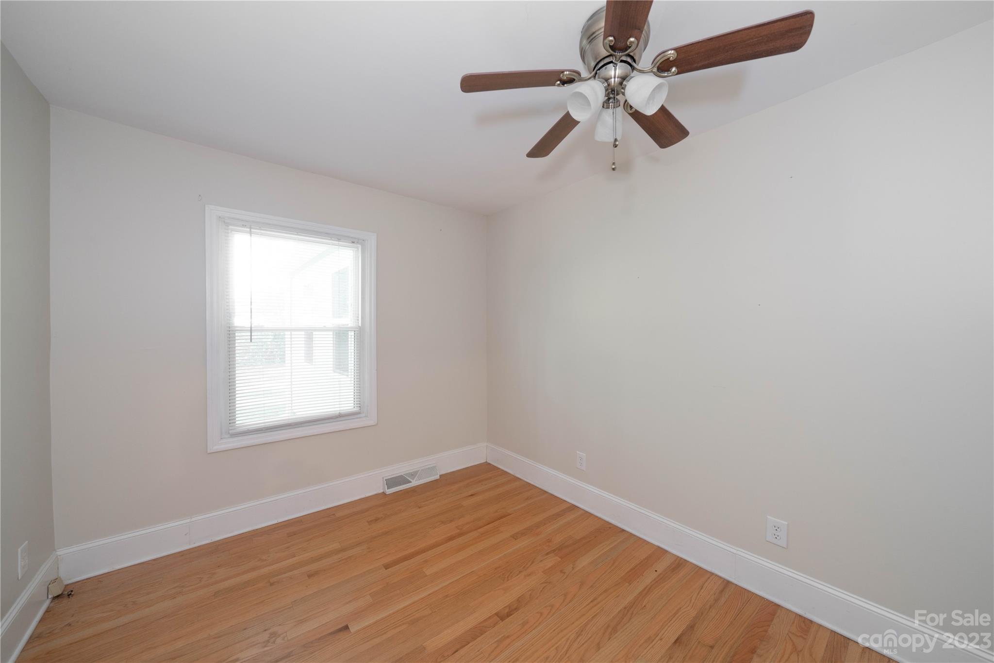 507 Cook Street Kannapolis, NC 28083 - Photo 29 of 38 an empty room with a window and a fan