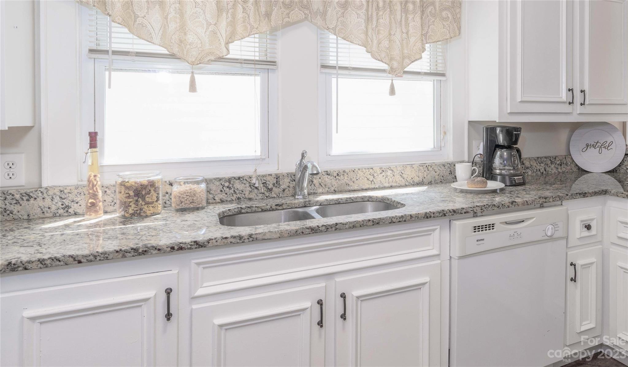 507 Cook Street Kannapolis, NC 28083 - Photo 31 of 38 a bathroom with kitchen island granite countertop a sink a window and cabinets