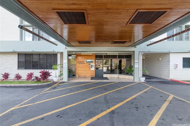 a view of a cars park in front of building