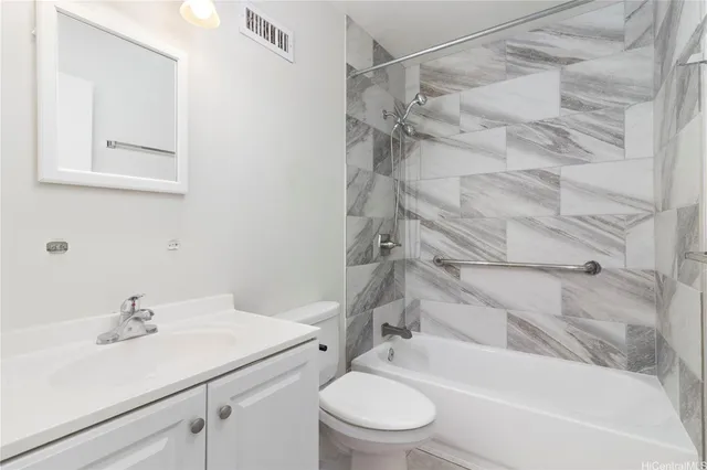 a bedroom with a bed and a potted plant