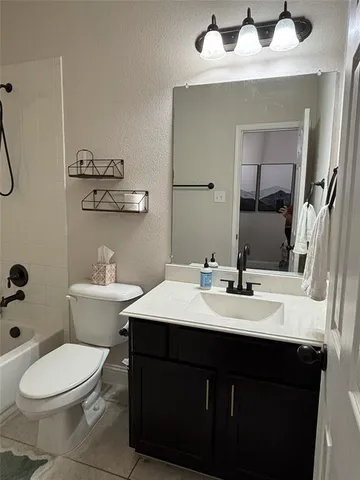 a bathroom with a toilet a sink and mirror