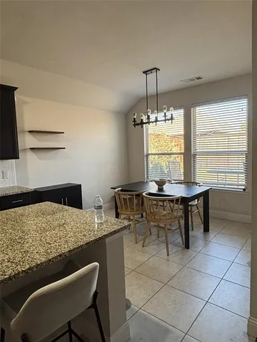a view of a dining room with furniture and window