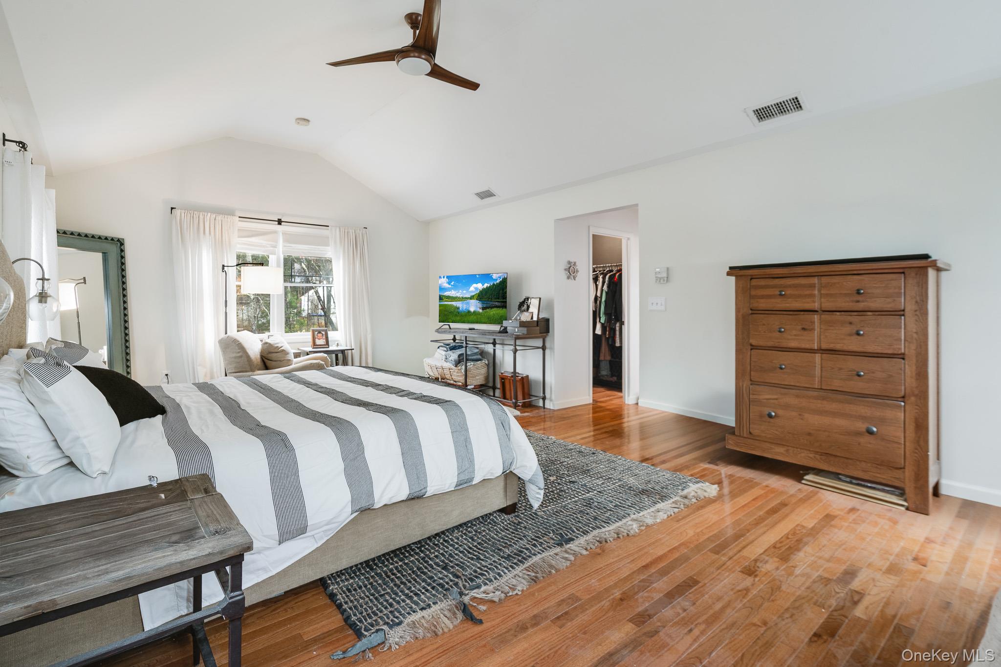 112 Pleasantview Road Pleasant Valley, NY 12569 - Photo 20 of 30 Bedroom featuring a walk in closet, lofted ceiling, wood-type flooring, and ceiling fan