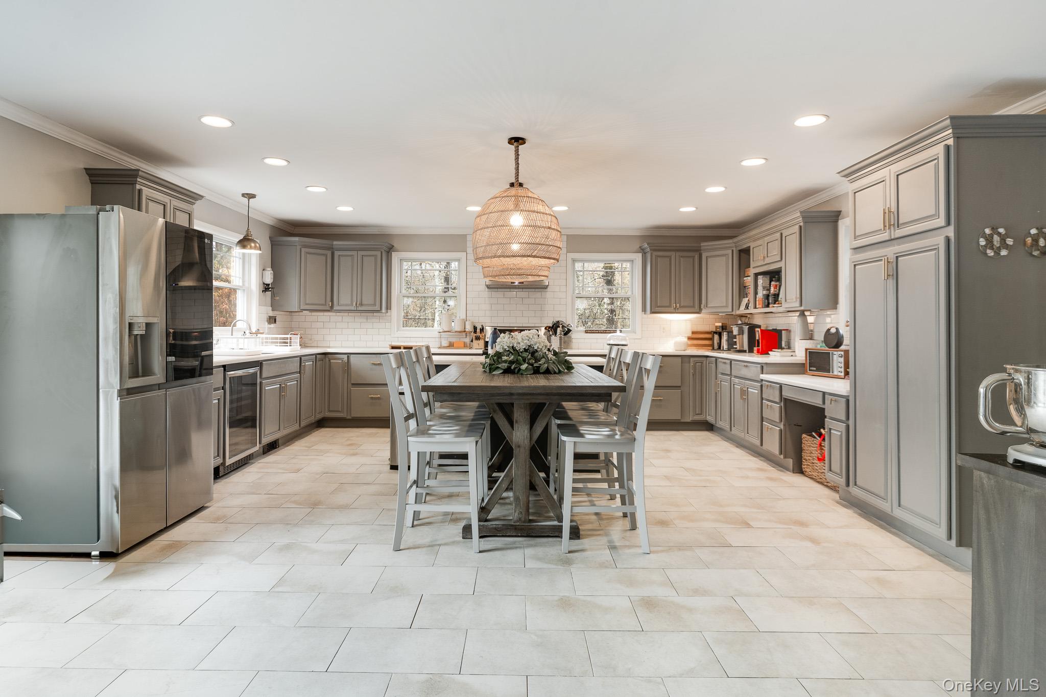 112 Pleasantview Road Pleasant Valley, NY 12569 - Photo 9 of 30 Kitchen featuring gray cabinetry, stainless steel fridge with ice dispenser, ornamental molding, pendant lighting, and wine cooler