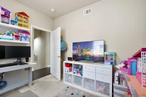 a bedroom with a bed and a flat screen tv