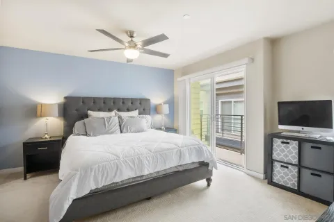 a bedroom with a bed and a ceiling fan