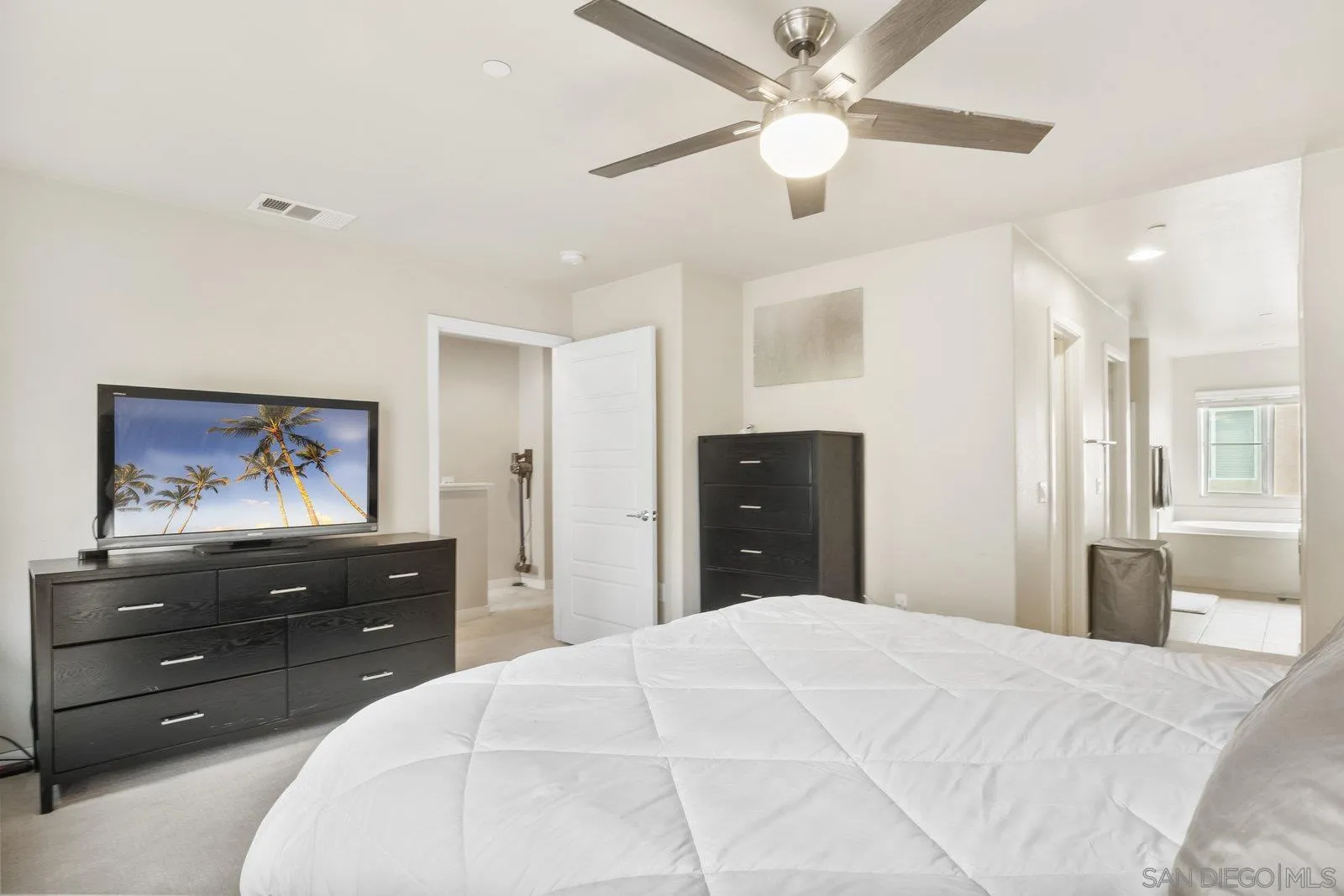 4541 Rainier Avenue, Unit 13 San Diego, CA 92120 - Photo 17 of 36 a bedroom with a bed and a dresser