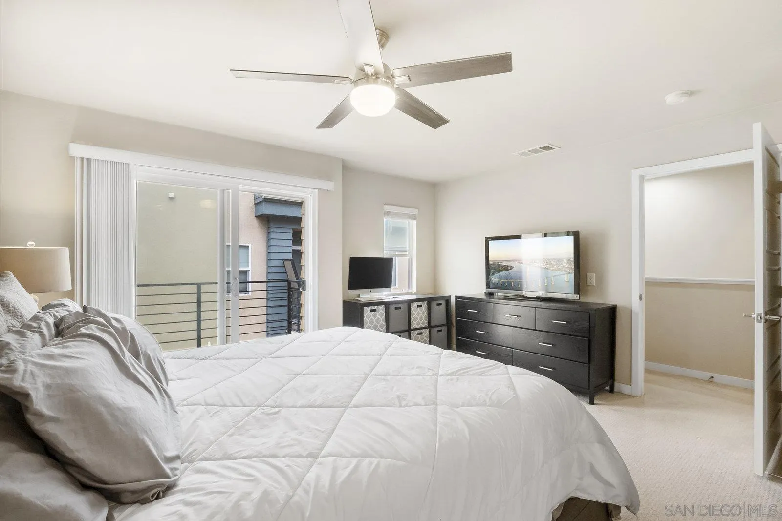 4541 Rainier Avenue, Unit 13 San Diego, CA 92120 - Photo 18 of 36 a bedroom with a bed and wooden floor