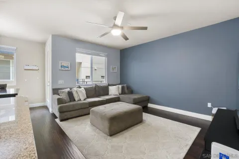 a living room with furniture and kitchen view