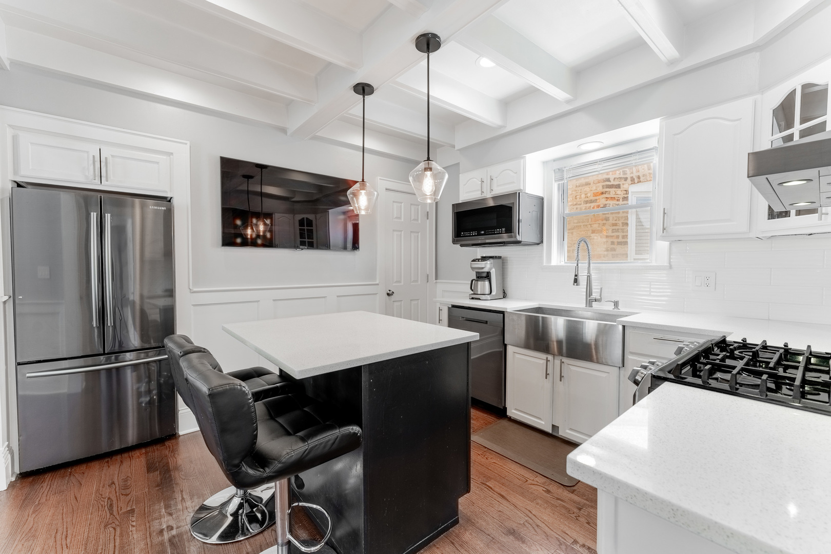 2610 North Major Avenue Chicago, IL 60639 - Photo 11 of 45 a kitchen with a table chairs refrigerator and microwave
