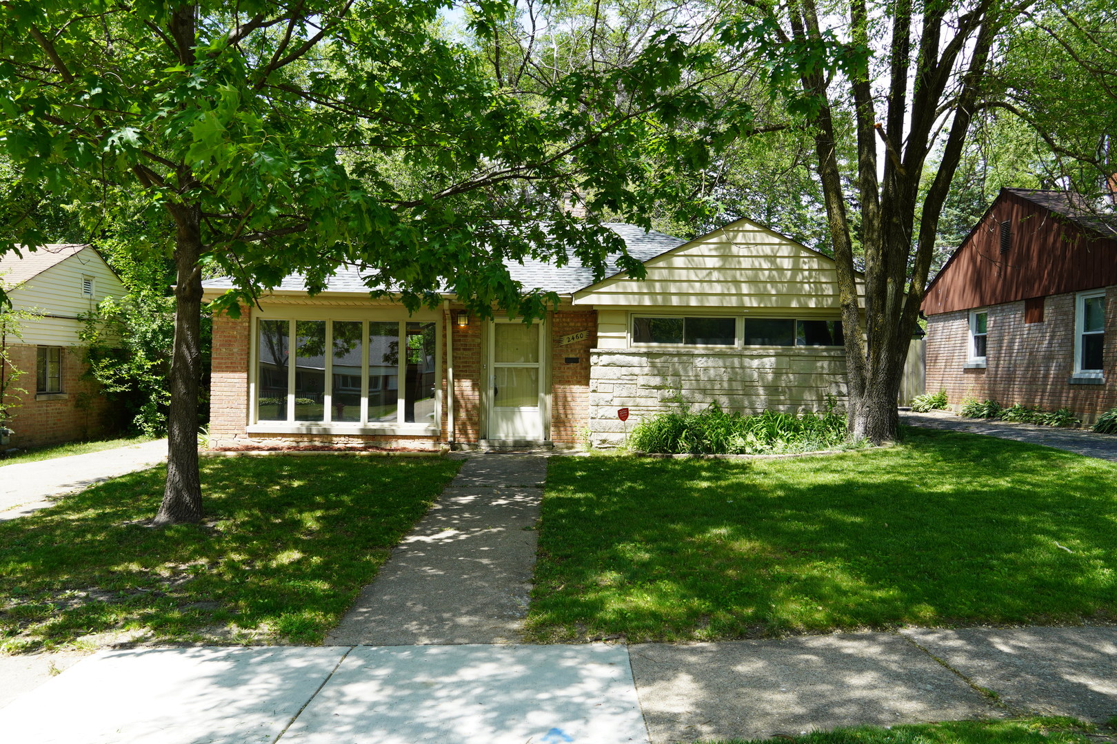 a front view of a house with a garden