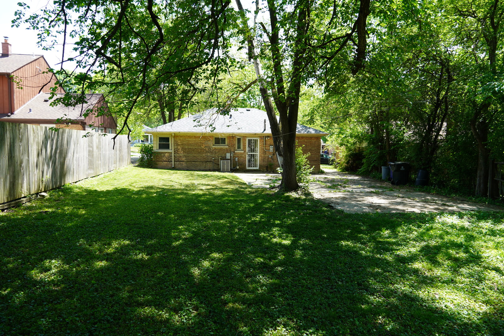 2460 Hawthorne Road Homewood, IL 60430 - Photo 11 of 11 a view of a backyard with large trees and a large tree