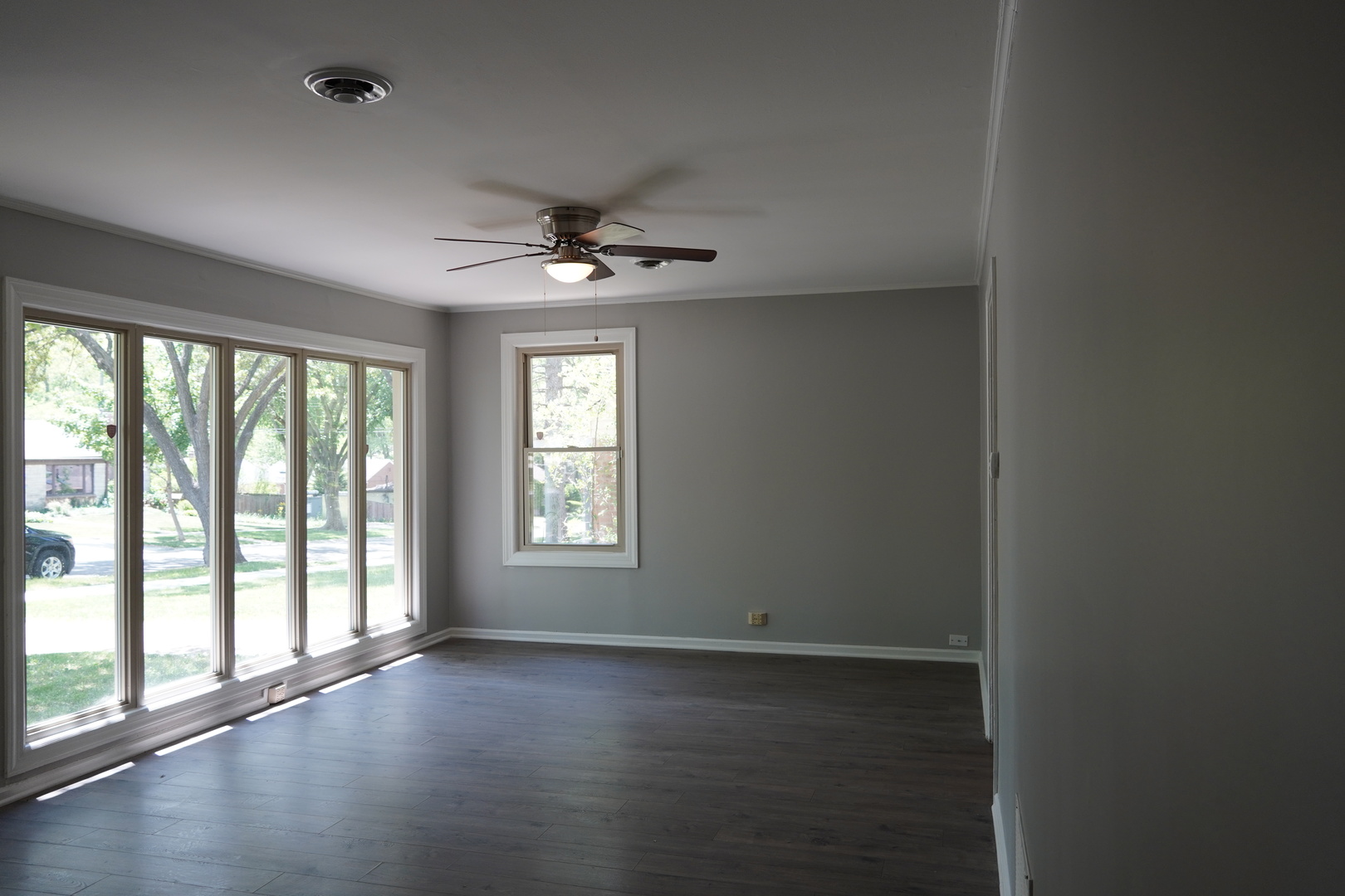 2460 Hawthorne Road Homewood, IL 60430 - Photo 3 of 11 a view of an empty room with a window and wooden floor
