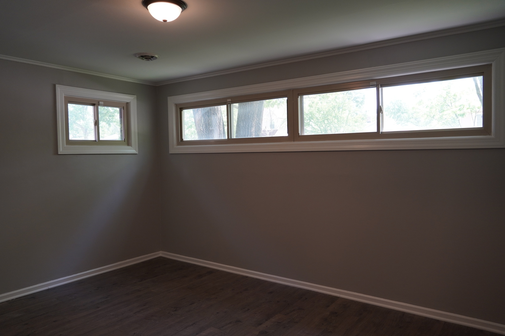 2460 Hawthorne Road Homewood, IL 60430 - Photo 5 of 11 a view of an empty room with wooden floor and a window