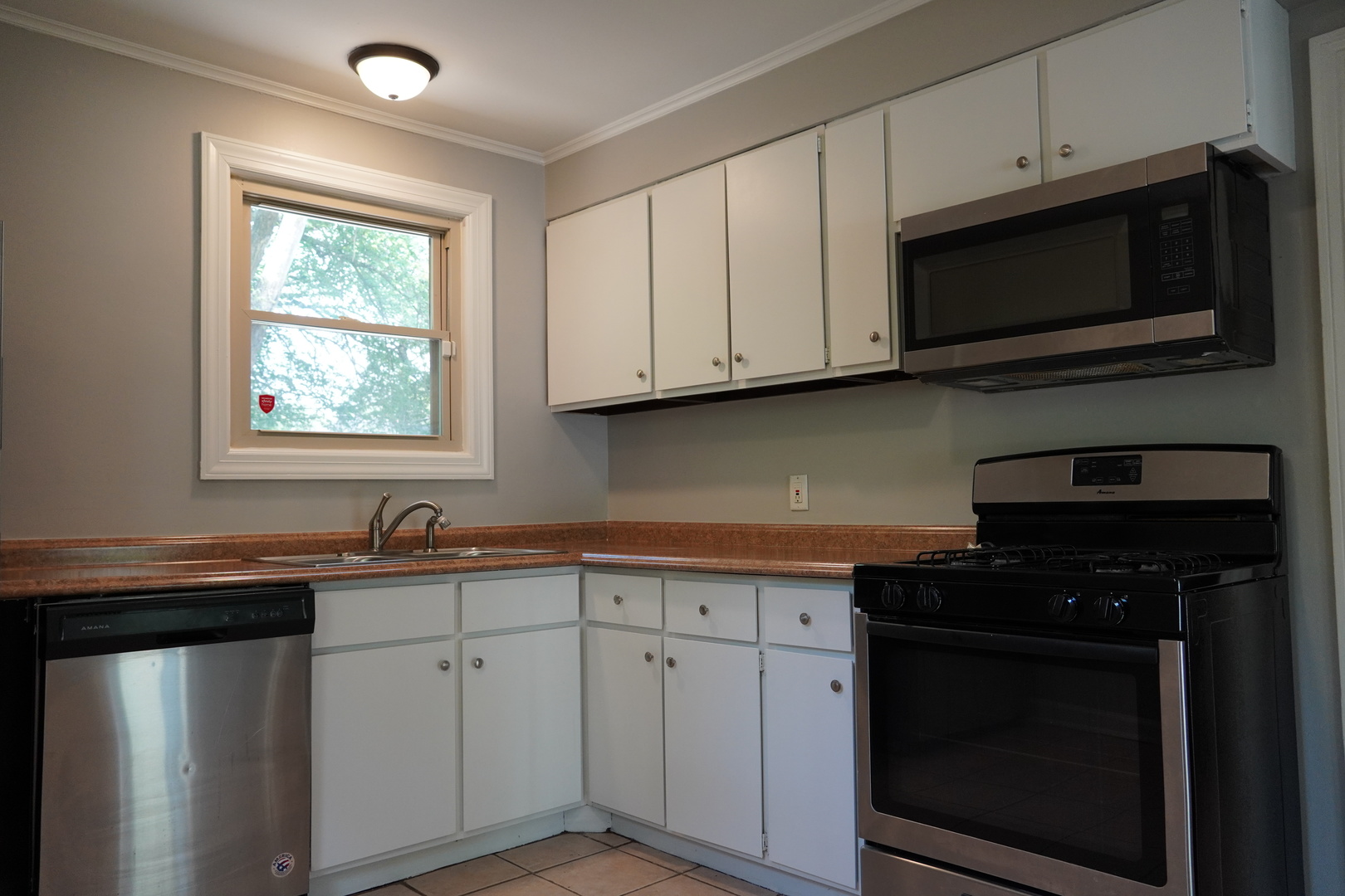 2460 Hawthorne Road Homewood, IL 60430 - Photo 8 of 11 a kitchen with stainless steel appliances granite countertop white cabinets granite counter tops and a window