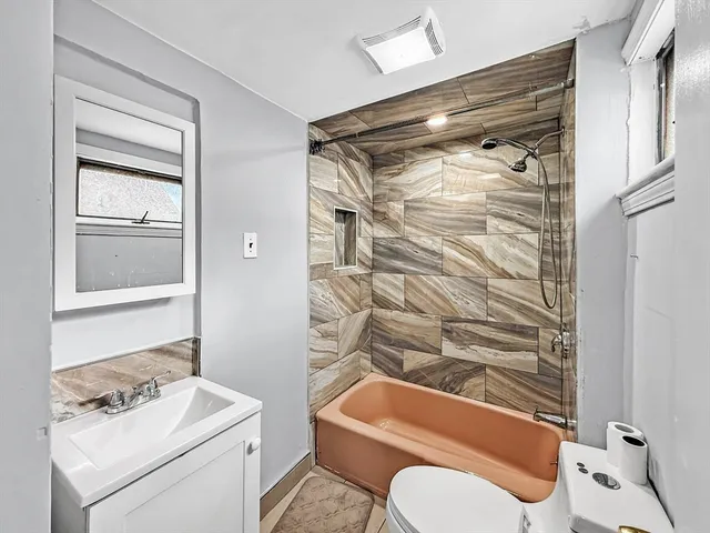 a bathroom with a sink toilet and shower