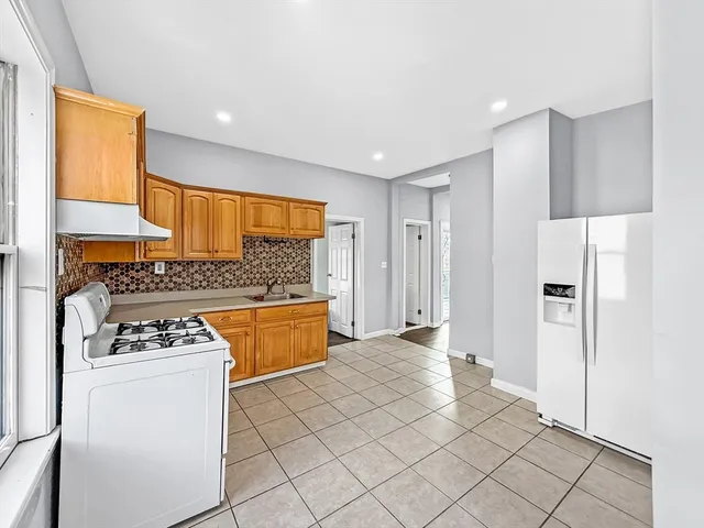 a kitchen with stainless steel appliances a refrigerator sink and stove
