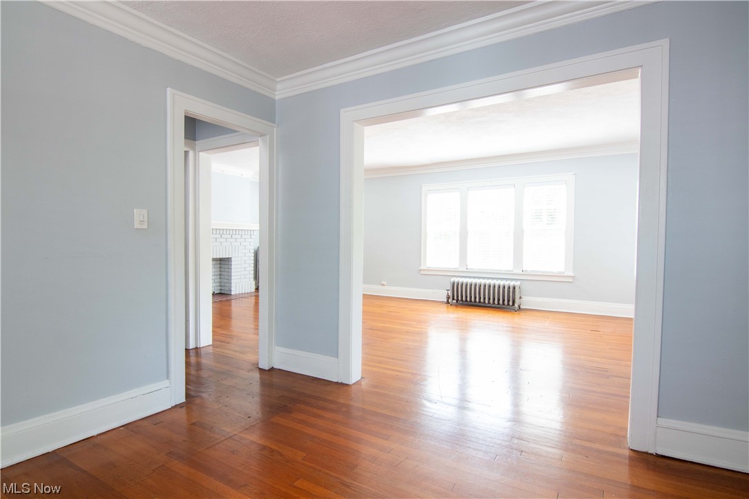 2261 Maplewood Road Cleveland, OH 44118 - Photo 26 of 44 Spare room featuring light hardwood / wood-style floors, crown molding, and radiator