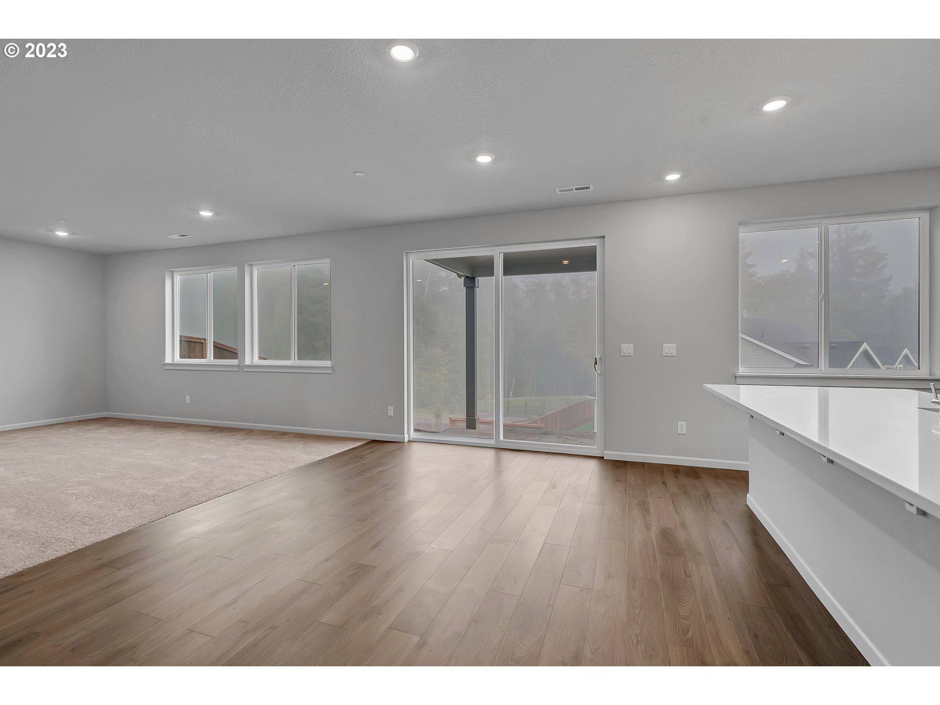 2818 South 6th Avenue Ridgefield, WA 98642 - Photo 17 of 33 a view of an empty room with wooden floor and a window