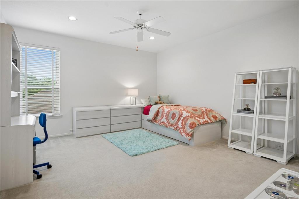 6419 Laurel Valley Road Dallas, TX 75248 - Photo 25 of 34 a bedroom with a bed and a window