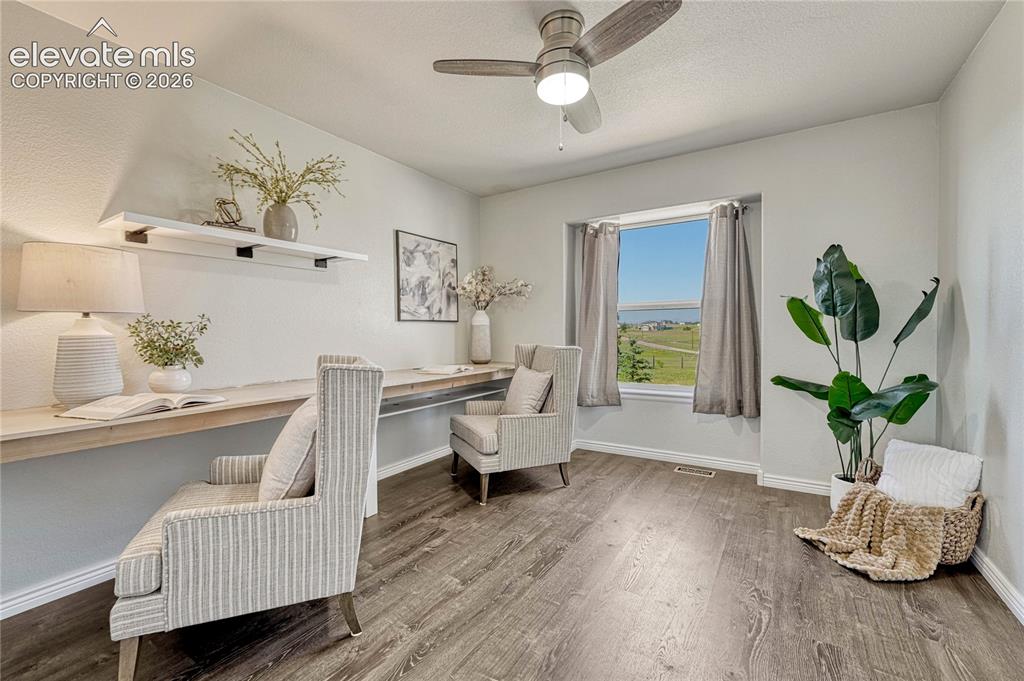 13695 Woodlake Road Elbert, CO 80106 - Photo 22 of 39 First of two additional main floor bedrooms with luxury vinyl flooring...would also make a great home office!