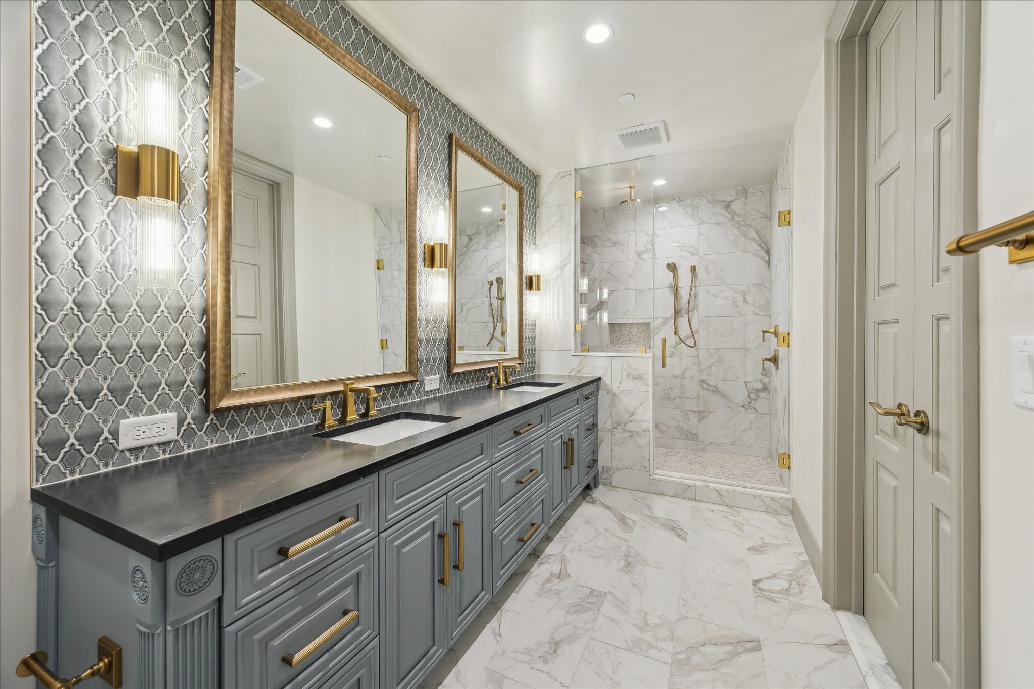 1717 Bissonnet Street, Unit 1105 Houston, TX 77005 - Photo 22 of 32 Guest bathroom with double sinks, Quartz counters, decorative sconces and tiled wall accent.