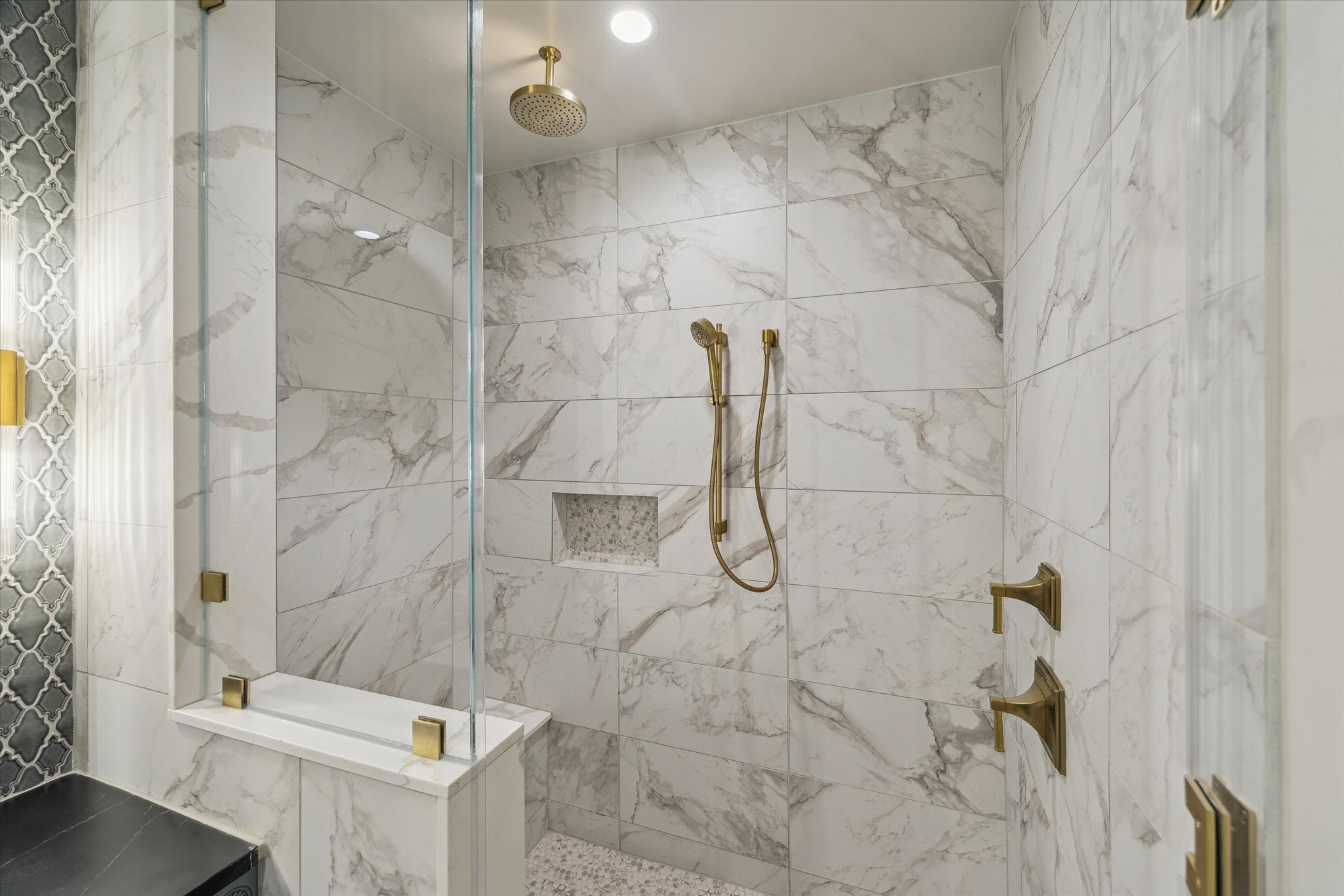 1717 Bissonnet Street, Unit 1105 Houston, TX 77005 - Photo 24 of 32 Oversized shower with bench, rain shower and handheld Kohler fixtures.