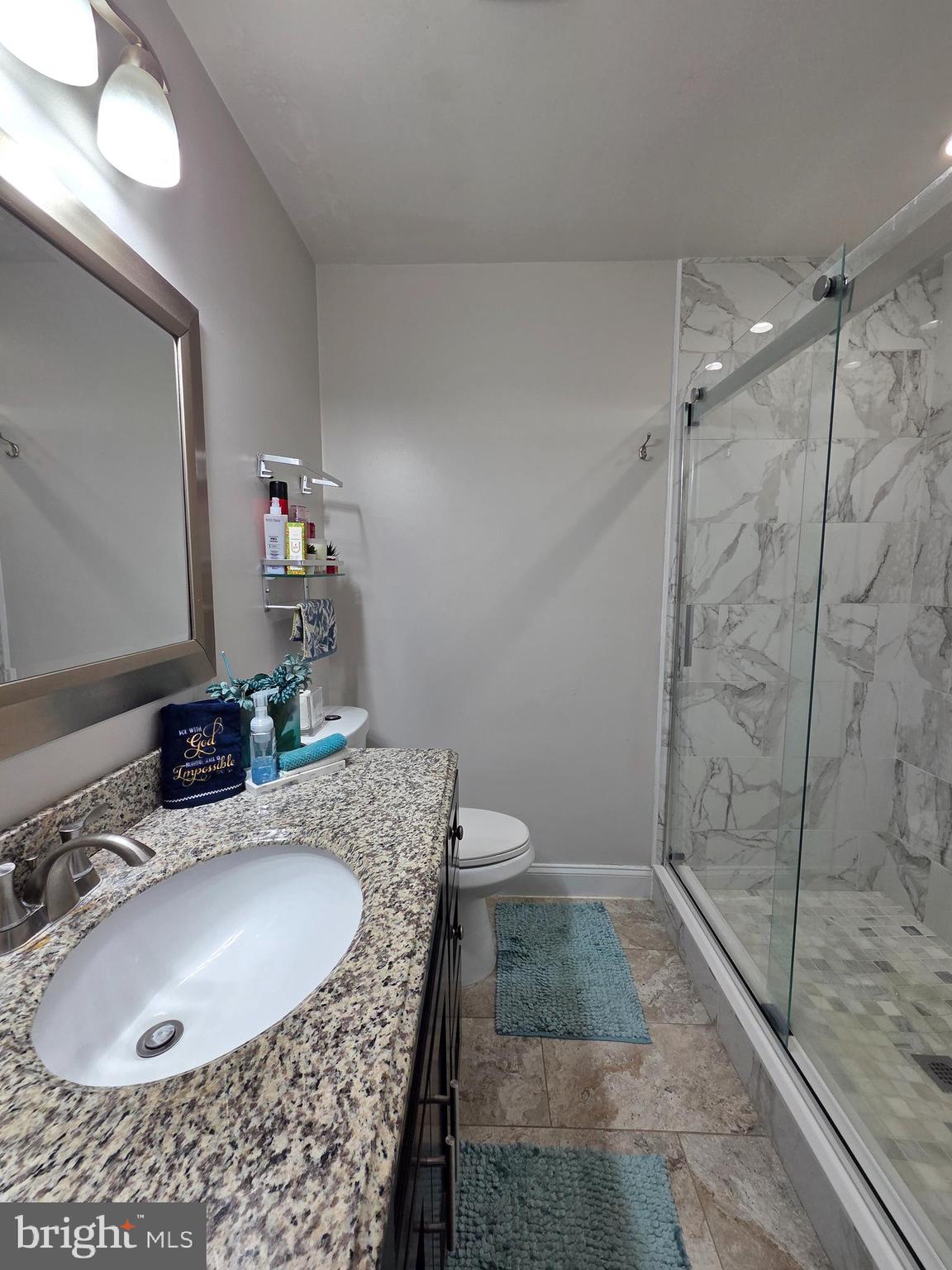 130 Laurel Court Reading, PA 19610 - Photo 22 of 29 a bathroom with a granite countertop sink a mirror and shower