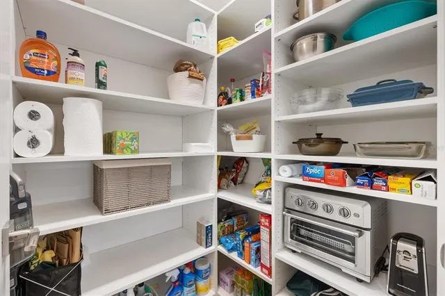 a very nice looking dining room with kitchen island furniture a chandelier and kitchen view
