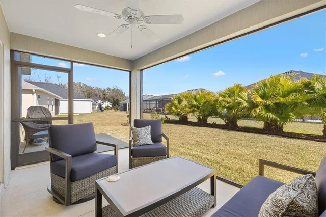 a living room with furniture and a floor to ceiling window