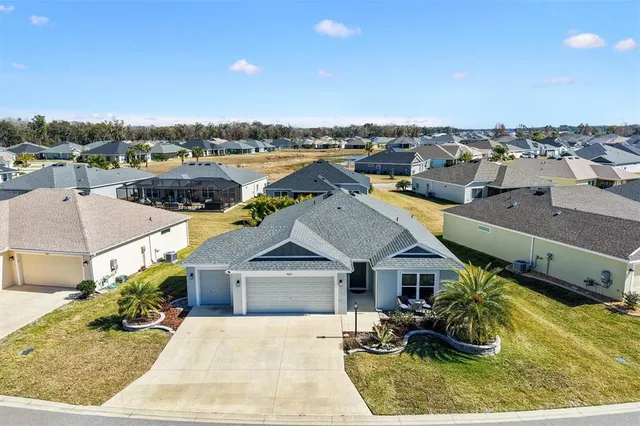 an aerial view of a houses with a swimming pool