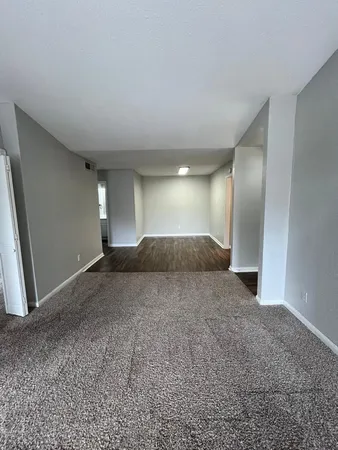 an empty room with windows and closet