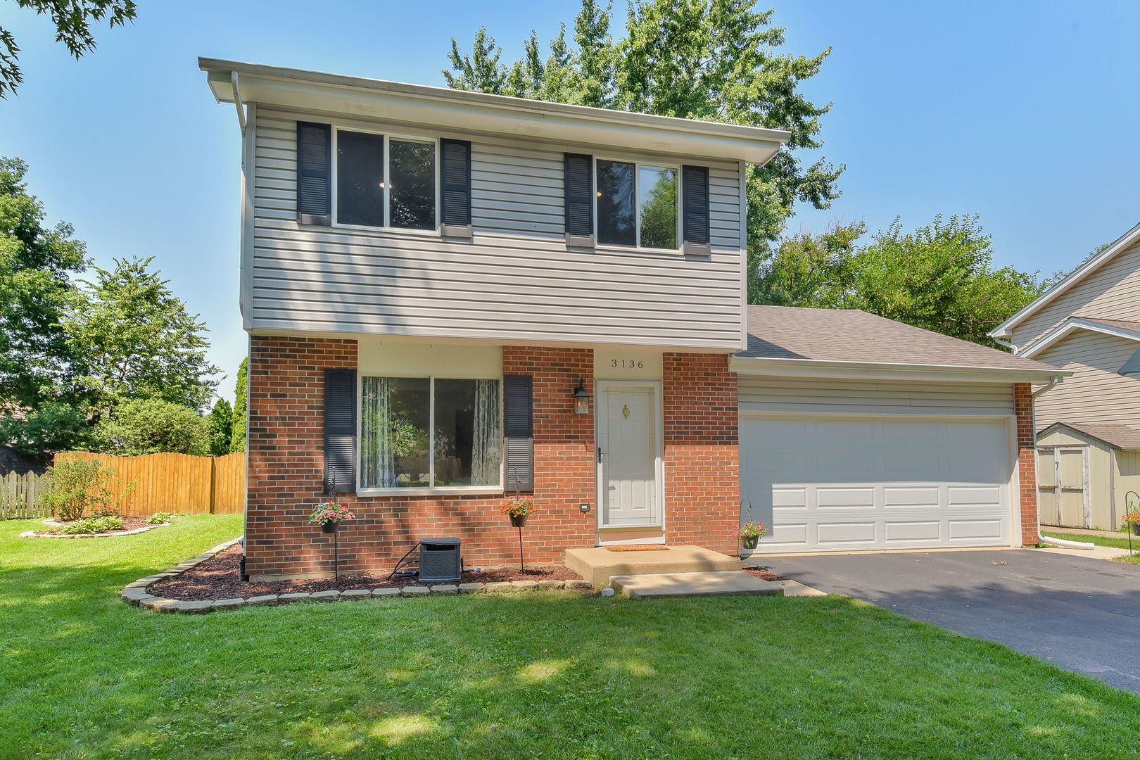 3136 Quincy Lane Aurora, IL 60504 - Photo 2 of 23 a front view of a house with a yard and garage