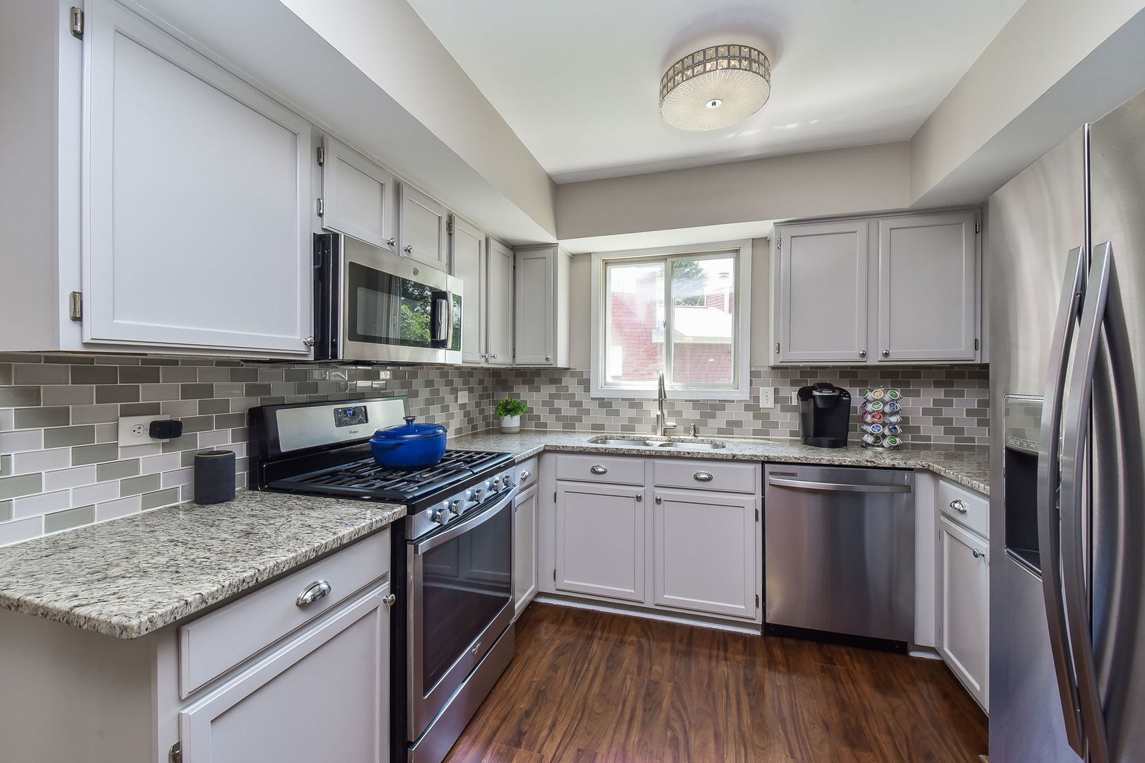 3136 Quincy Lane Aurora, IL 60504 - Photo 7 of 23 a kitchen with stainless steel appliances granite countertop a stove a sink dishwasher and a microwave oven with cabinets