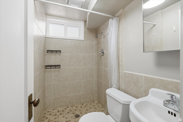 744 North 500 East Logan, UT 84321 - Photo 23 of 29 Basement Full bath with a shower stall and tile walls