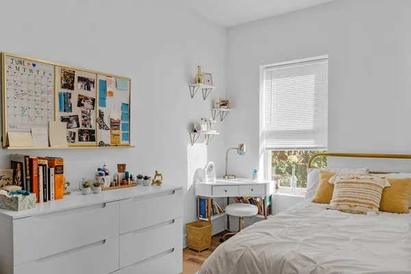 a bedroom with a bed and a window