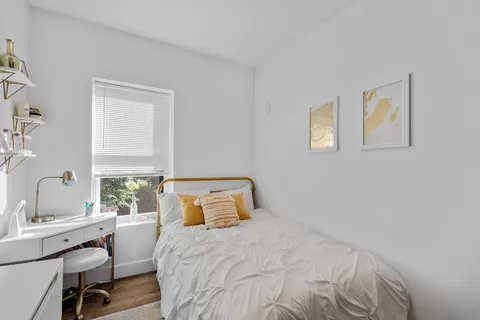 a bedroom with a bed and a table