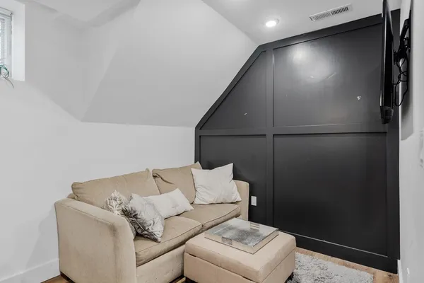 a living room with furniture and a ceiling fan
