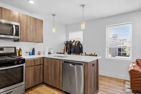 a kitchen with a sink stove and microwave